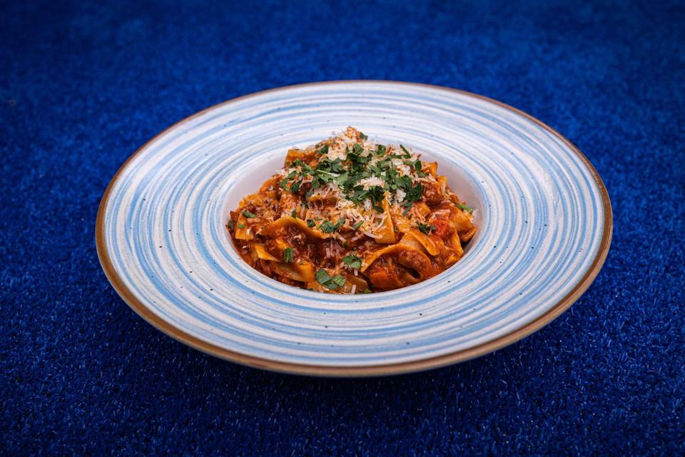 Pasta-Teller auf dem blauen Hartplatz